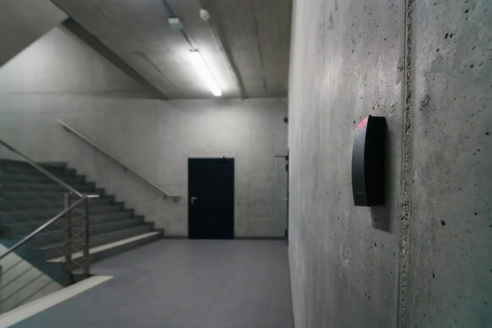 Card reader beside a secured door in a building corridor
