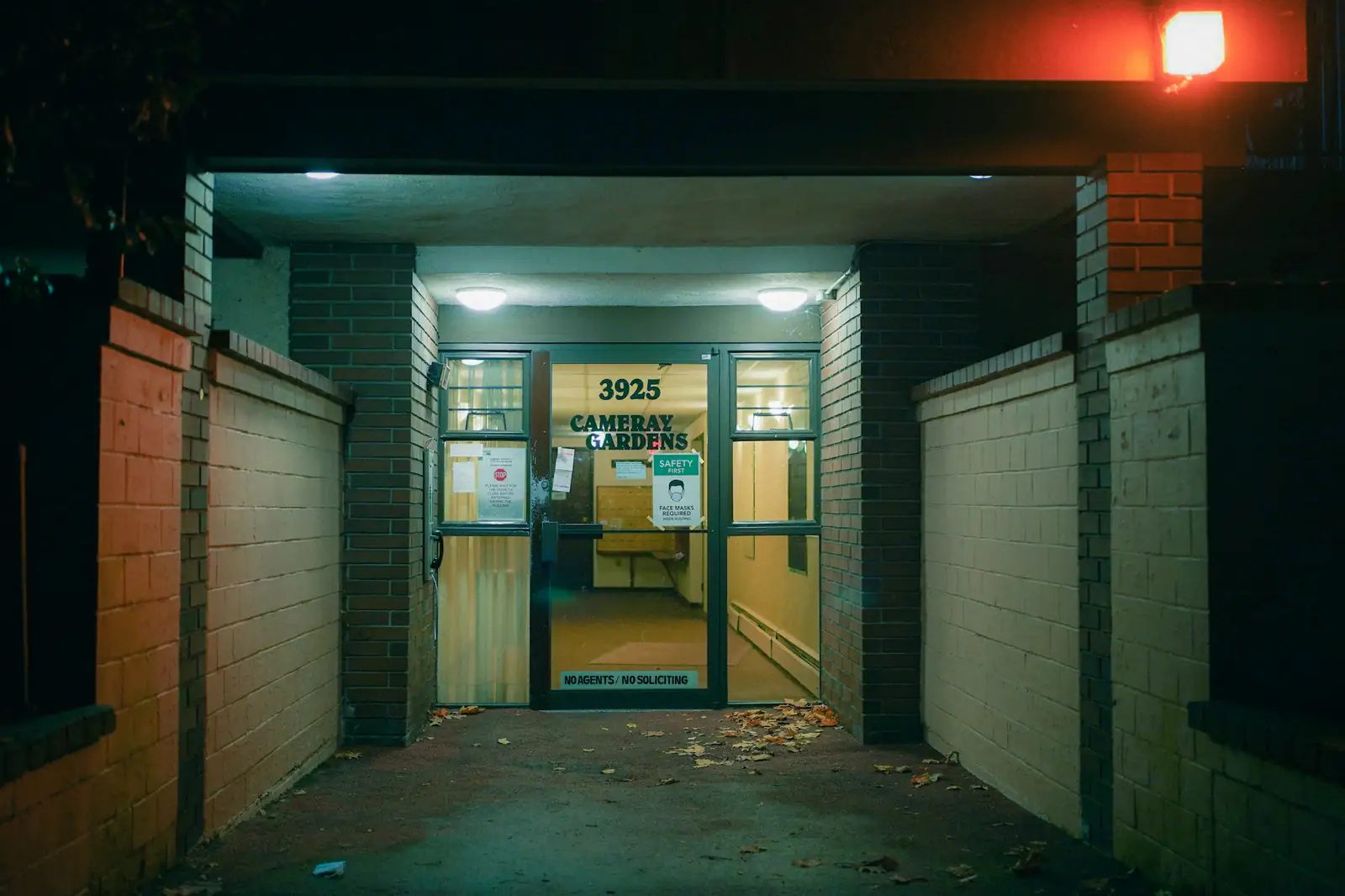 Lit condo building entrance at night