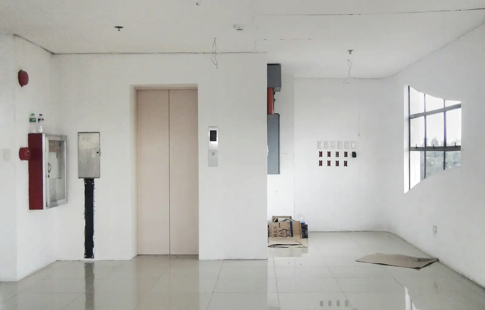 Elevator doors in a bright building hallway