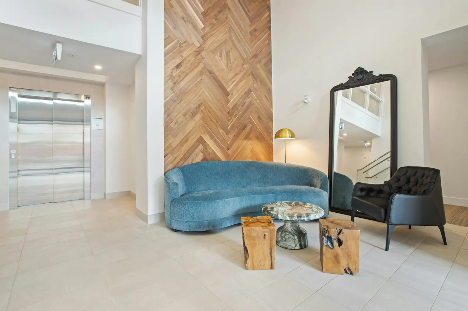 Residential building lobby with seating and an elevator