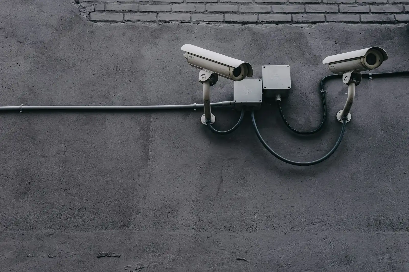 Two security cameras mounted on a building wall