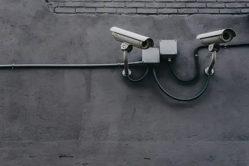 Two security cameras mounted on a building wall